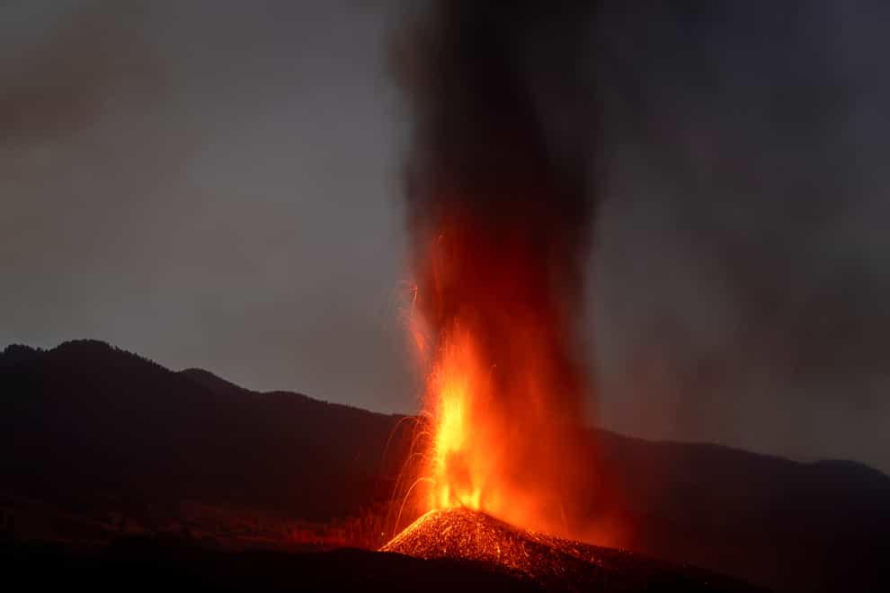 Lava from a volcano eruption flows on the island of La Palma in the Canaries, Spain, Thursday, Sept. 23, 2021. A volcano on a small Spanish island in the Atlantic Ocean erupted on Sunday, forcing the evacuation of thousands of people. Experts say the volcanic eruption and its aftermath on a Spanish island could last for up to 84 days. (AP Photo/Emilio Morenatti)
