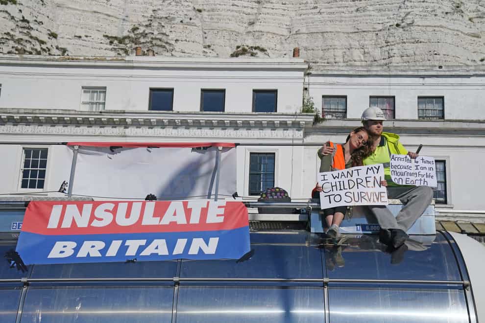 Protesters from Insulate Britain sit on top of a vehicle as they block the A20 in Kent, which provides access to the Port of Dover in Kent (Gareth Fuller/PA)