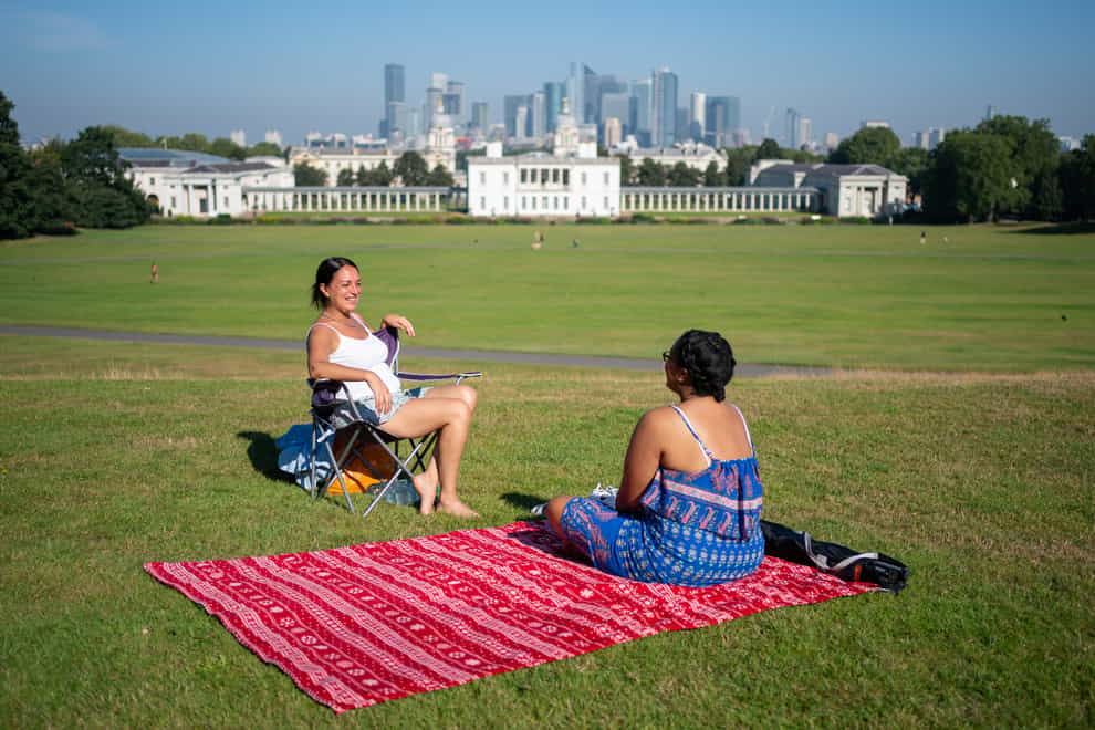 People enjoy the sun in Greenwich Park, London (Dominic Lipinski/PA)