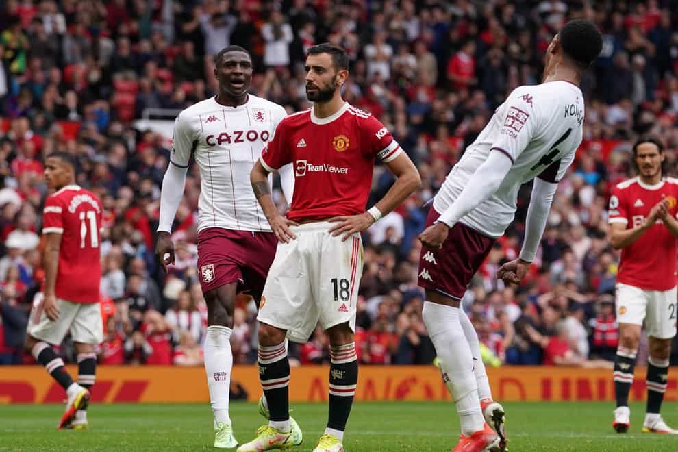 Bruno Fernandes, centre, reacts after missing a late penalty after Villa goalscorer Kortney Hause, left, handled (Martin Rickett/PA)