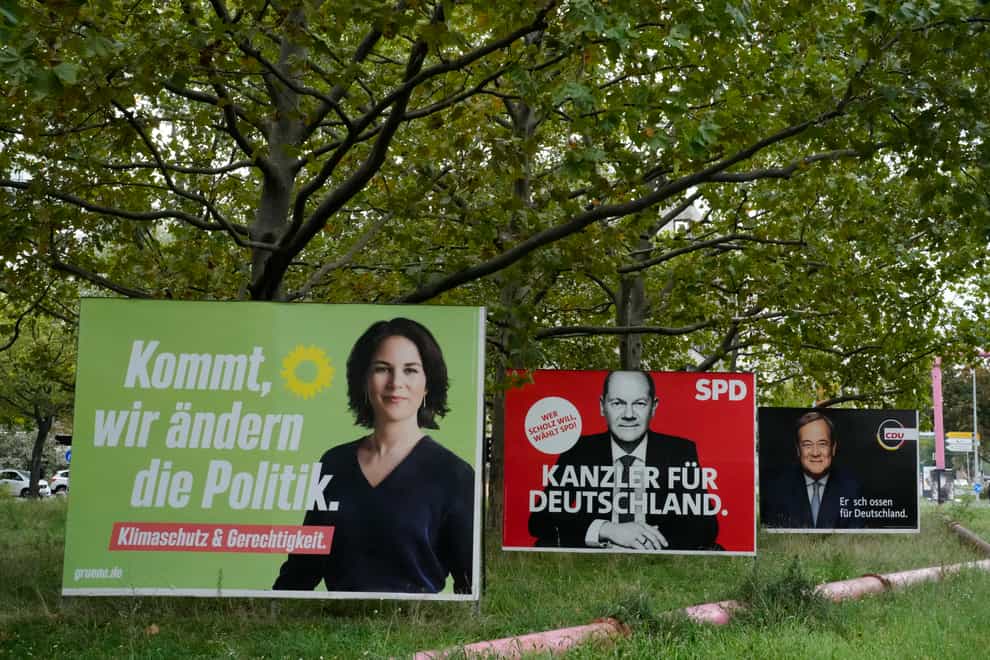 Election campaign billboards of candidates for chancellery Annalena Baerbock, Olaf Scholz and Armin Laschet displayed in central Berlin (Markus Schreiber/AP)