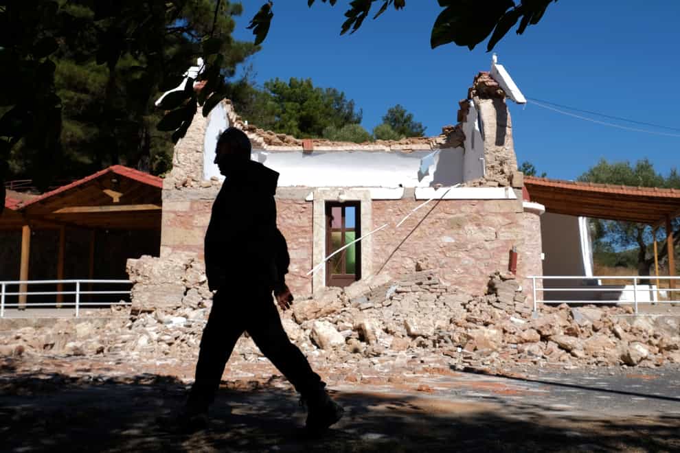 A man walks past a damaged Greek Orthodox chapel in Crete following the earthquake (Harry Nikos/AP)