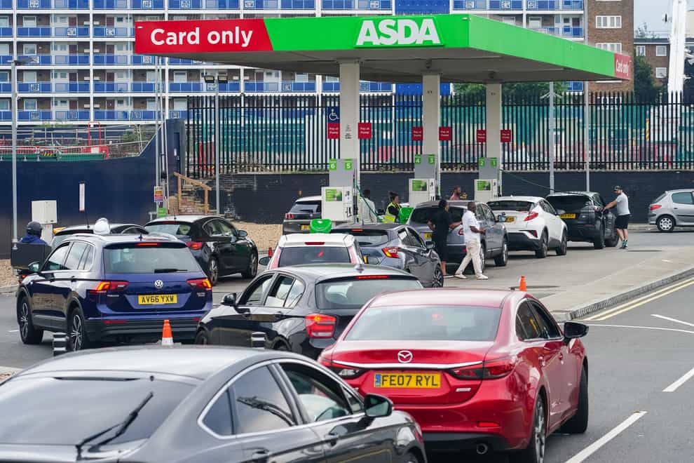 Cars queue for fuel at an Asda petrol station in south London (Dominic Lipinski/PA)
