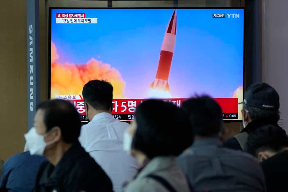 People watch a TV showing a file image of North Korea’s missile launch during a news program at the Seoul Railway Station in Seoul, South Korea (Ahn Young-joon/AP)