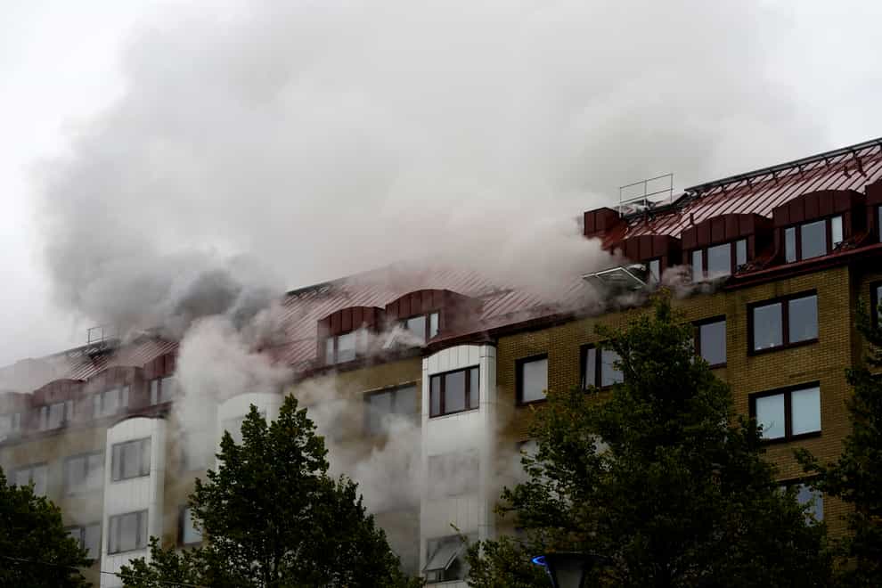 Smoke billows from an apartment building after an explosion in Annedal, central Gothenburg (TT via AP)