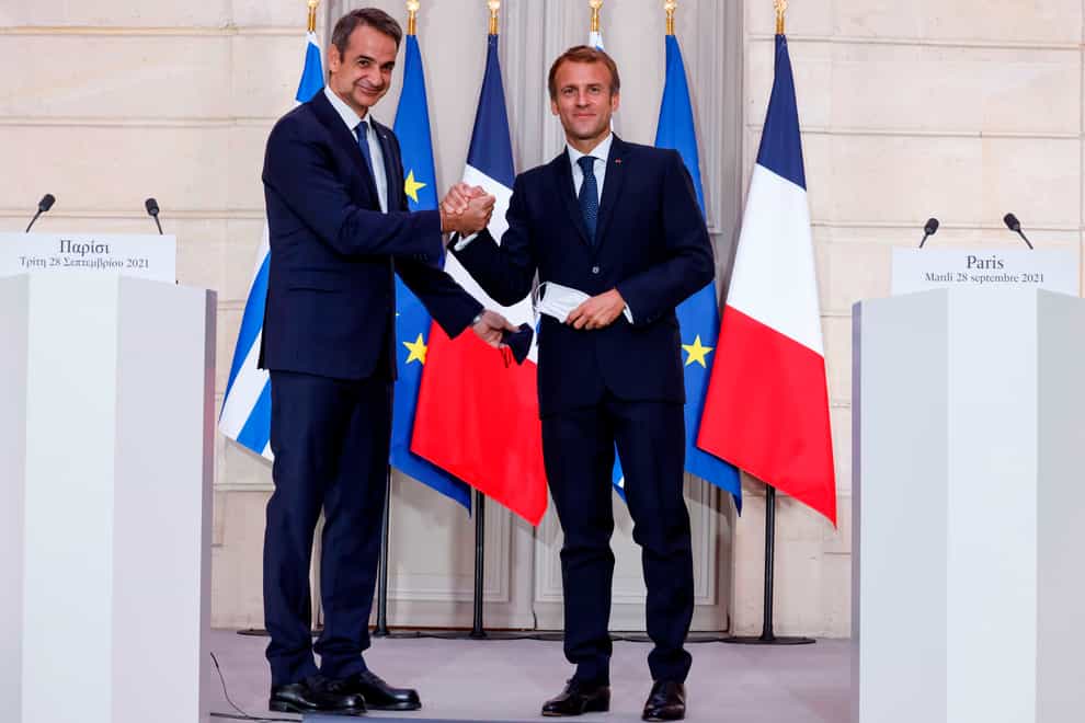 Greek prime minister Kyriakos Mitsotakis and French president Emmanuel Macron (AP)