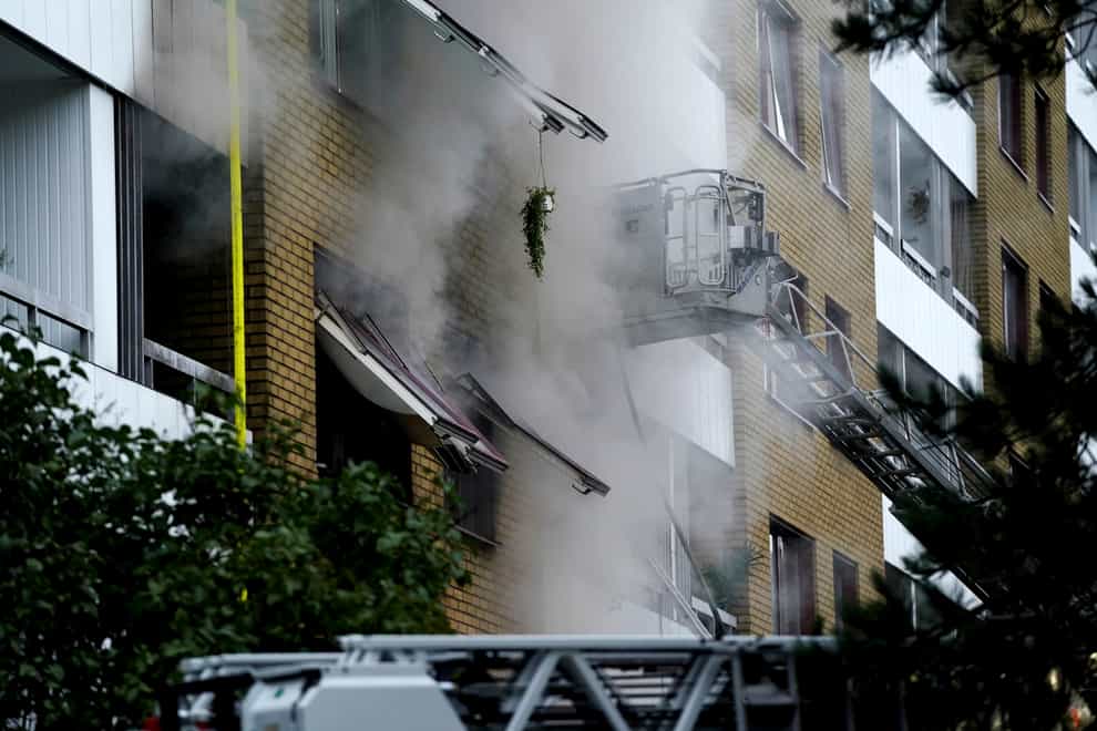Smoke billows from an apartment building after an explosion in Annedal (TT via AP)
