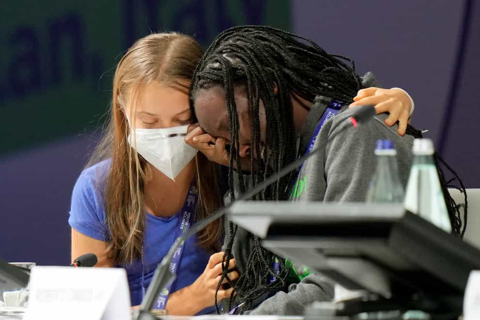 Ugandan climate activist Vanessa Nakate is comforted by Swedish activist Greta Thunberg (AP)