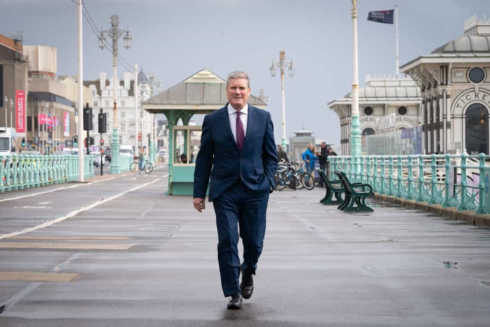 Labour leader Sir Keir Starmer walks along Brighton seafront promenade during the Labour Party conference (Stefan Rousseau/PA)