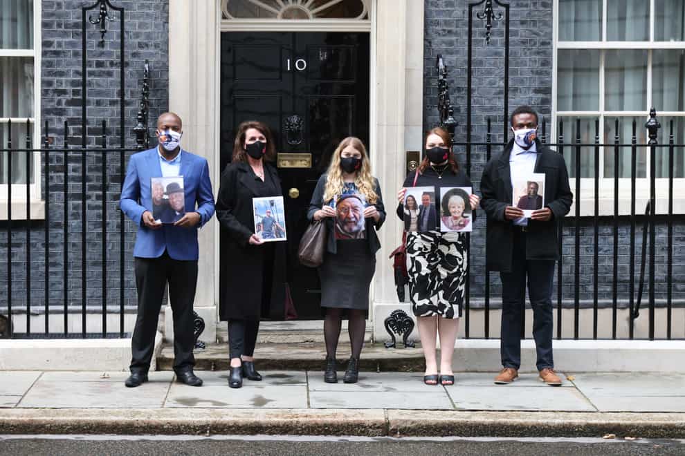 Members of the Covid-19 Bereaved Families for Justice group holding photos of loved ones outside 10 Downing Street, London, after their private meeting with Boris Johnson (James Manning/PA)