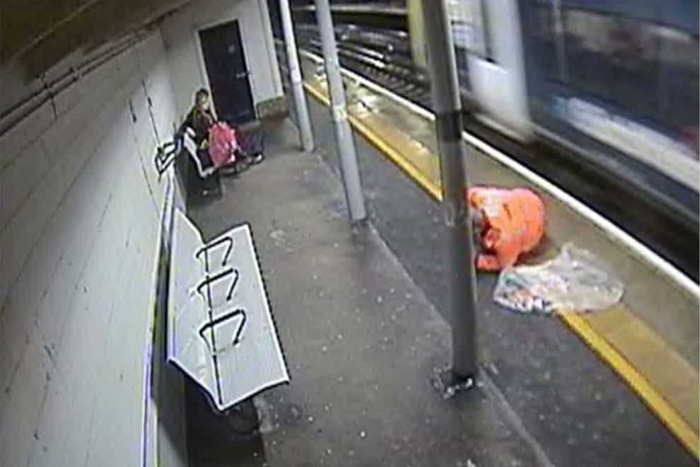 A rail worker removing rubbish from train tracks narrowly avoided being hit by a train, an investigation has found (RAIB/PA)