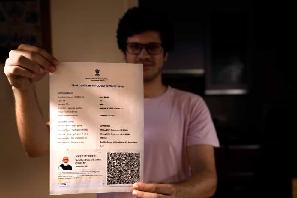 A boy displays his Covishield vaccination certificate in New Delhi, India (Manish Swarup/AP)