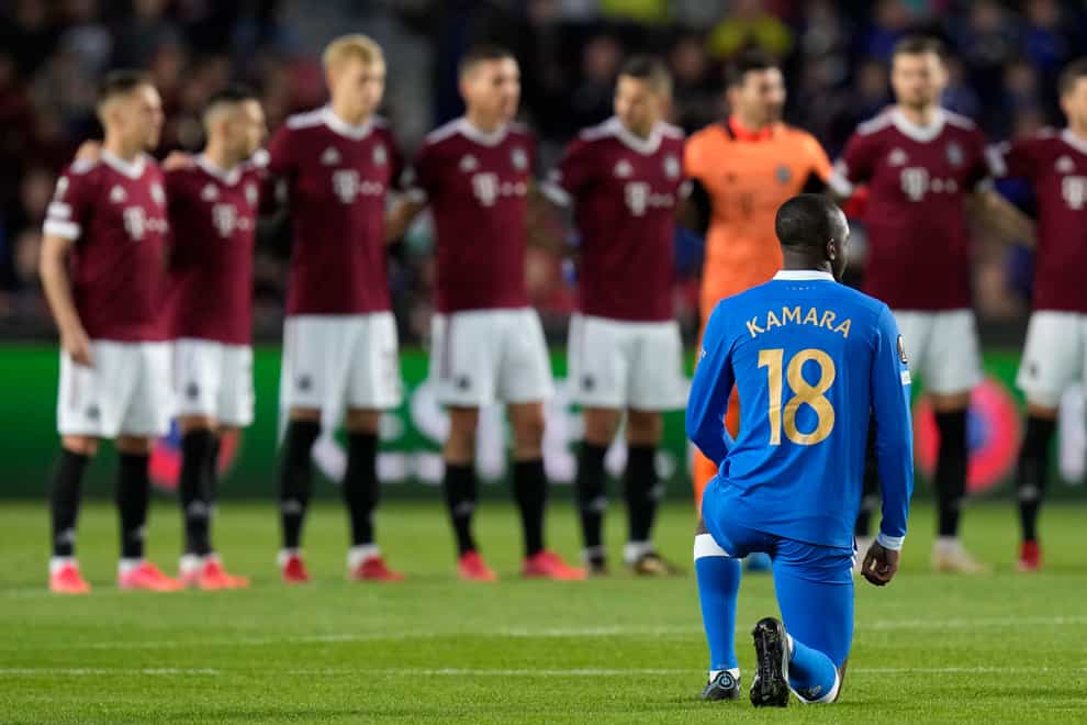 Glen Kamara kneels before the start of the Europa League match (Petr David Josek/AP)