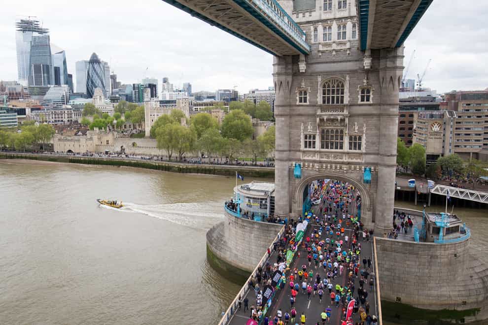 Runners cross Tower Bridge during the 2019 Virgin Money London Marathon (PA)