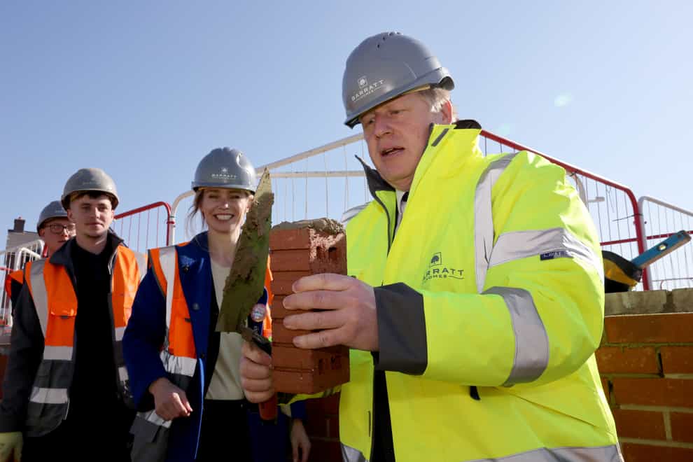Stroud MP Siobhan Baillie (centre) with Prime Minister Boris Johnson during a visit to a Barratt Homes development site in Great Oldbury, Gloucestershire (PA)