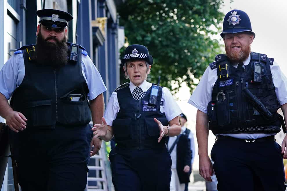 Metropolitan Police Commissioner Dame Cressida Dick alongside police officers during a walkabout in Westminster (Victoria Jones/PA)