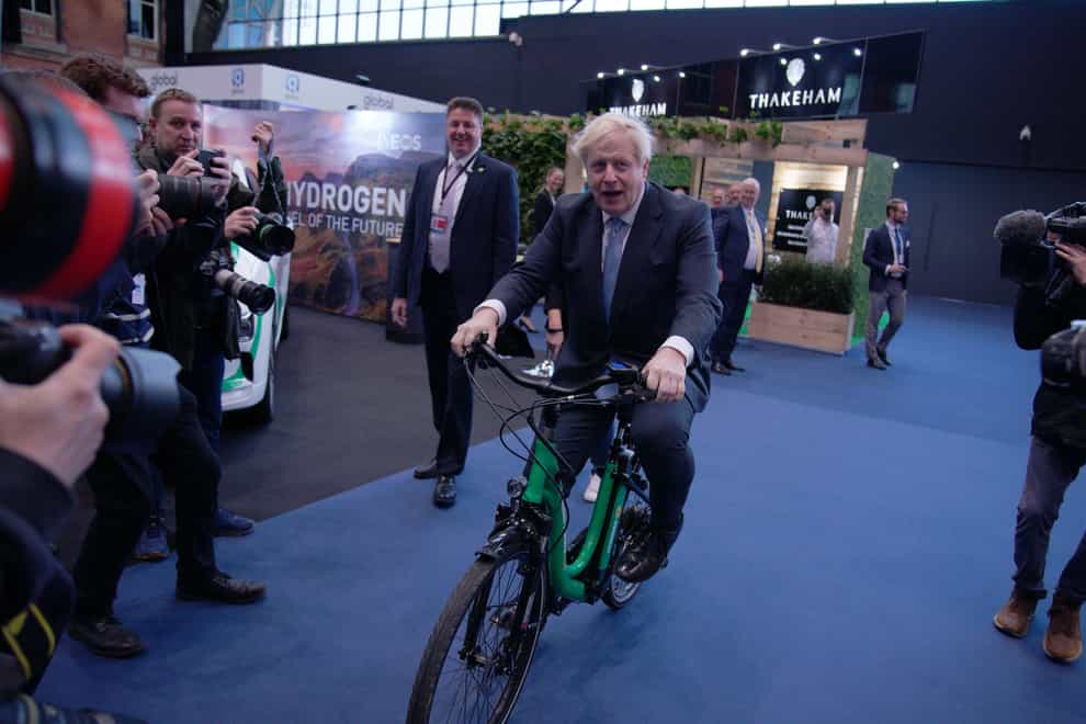 Prime Minister Boris Johnson on a bicycle in the Manchester Central Convention Complex (Peter Byrne/PA)