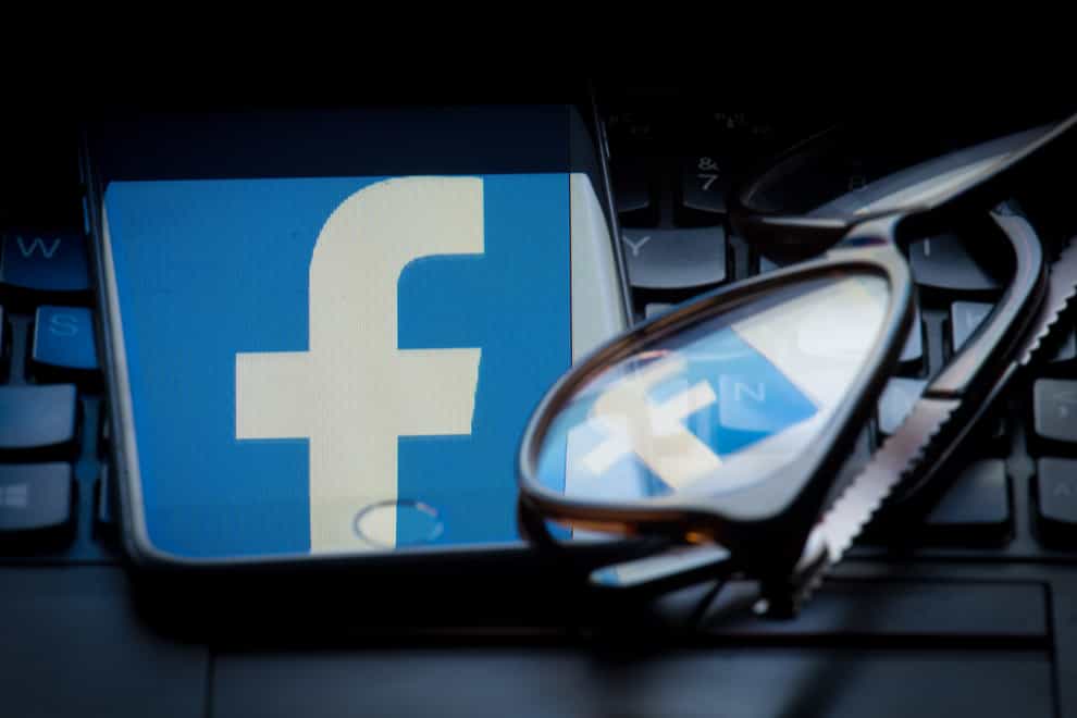 The logo of social networking site Facebook is seen reflected on the screen of a smartphone and a pair of glasses resting on a laptop keyboard. PRESS ASSOCIATION Photo. Picture date: Sunday March 25, 2018. Photo credit should read: Dominic Lipinski/PA Wire