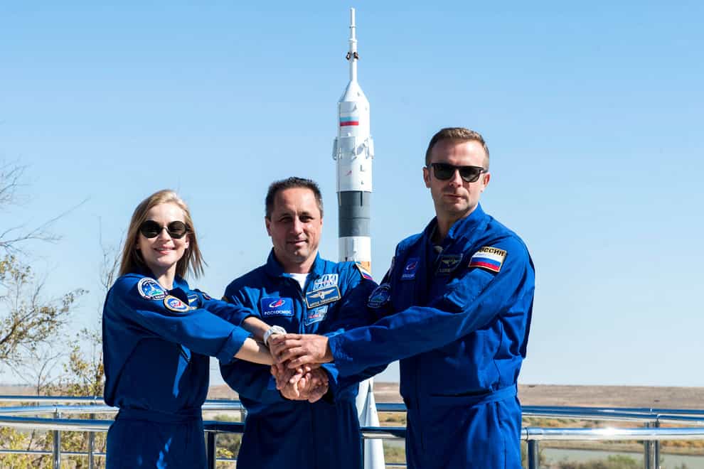 In this handout photo released by Roscosmos, Actress Yulia Peresild, left, director Klim Shipenko’ right, and cosmonaut Anton Shkaplerov, members of the prime crew of Soyuz MS-19 spaceship pose at the Russian launch facility in the Baikonur Cosmodrome, Kazakhstan, Monday, Sept. 27, 2021. PIn a historic first, Russia is set to launch an actress and a film director to space to make a feature film in orbit. Actress Yulia Peresild and director Klim Shipenko are set to blast off Tuesday for the International Space Station in a Russian Soyuz spacecraft together with Anton Shkaplerov, a veteran of three space missions. (Andrey Shelepin, Roscosmos Space Agency via AP)