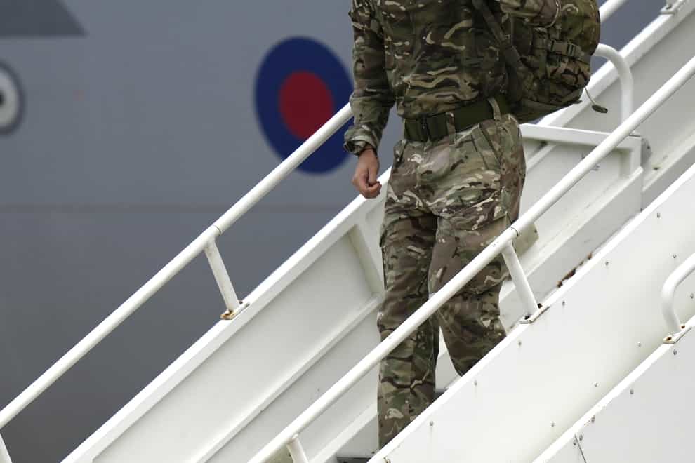 A member of the British armed forces disembarks from an RAF aircraft after returning from Kabul airport in Afghanistan (Alastair Grant/PA)