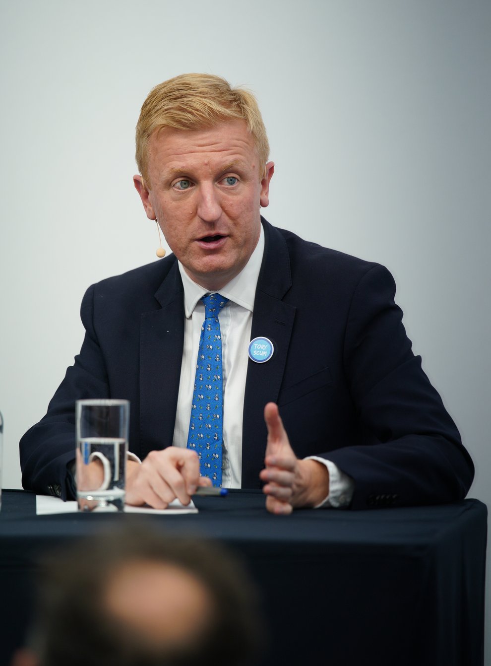Conservative Party chairman Oliver Dowden wearing a ‘Tory Scum’ badge during the Conservative Party Conference in Manchester (PA)