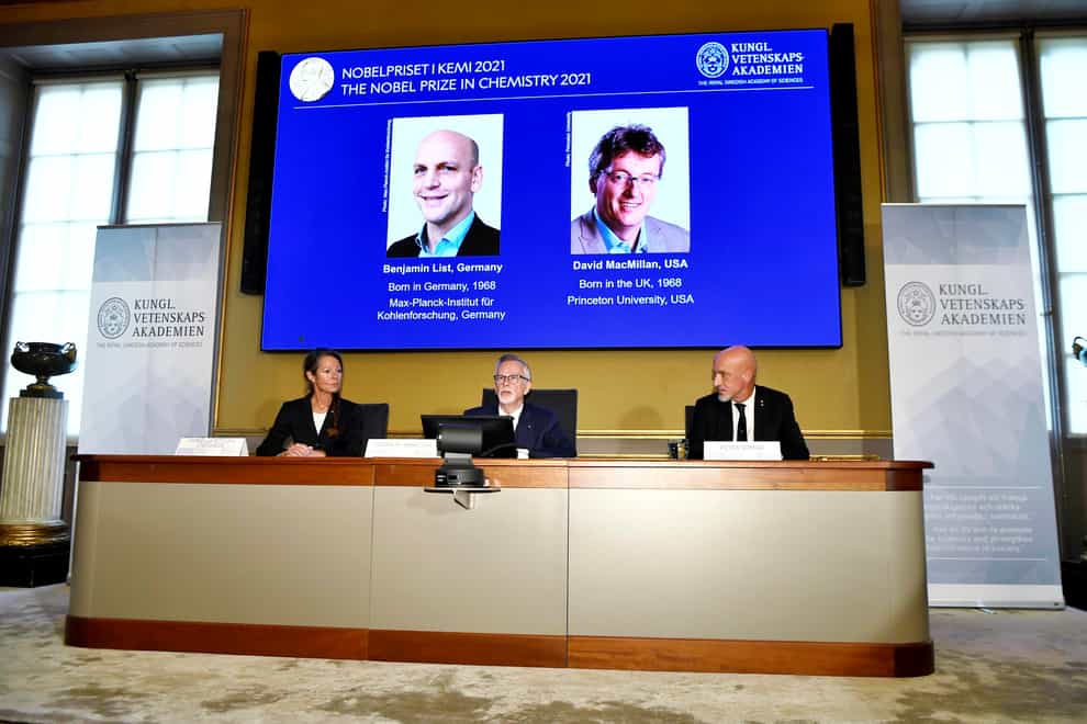 Goran K Hansson, permanent secretary of the Royal Swedish Academy of Sciences, centre, announces the winners of the 2021 Nobel Prize in chemistry (Claudio Bresciani/TT New Agency via AP)