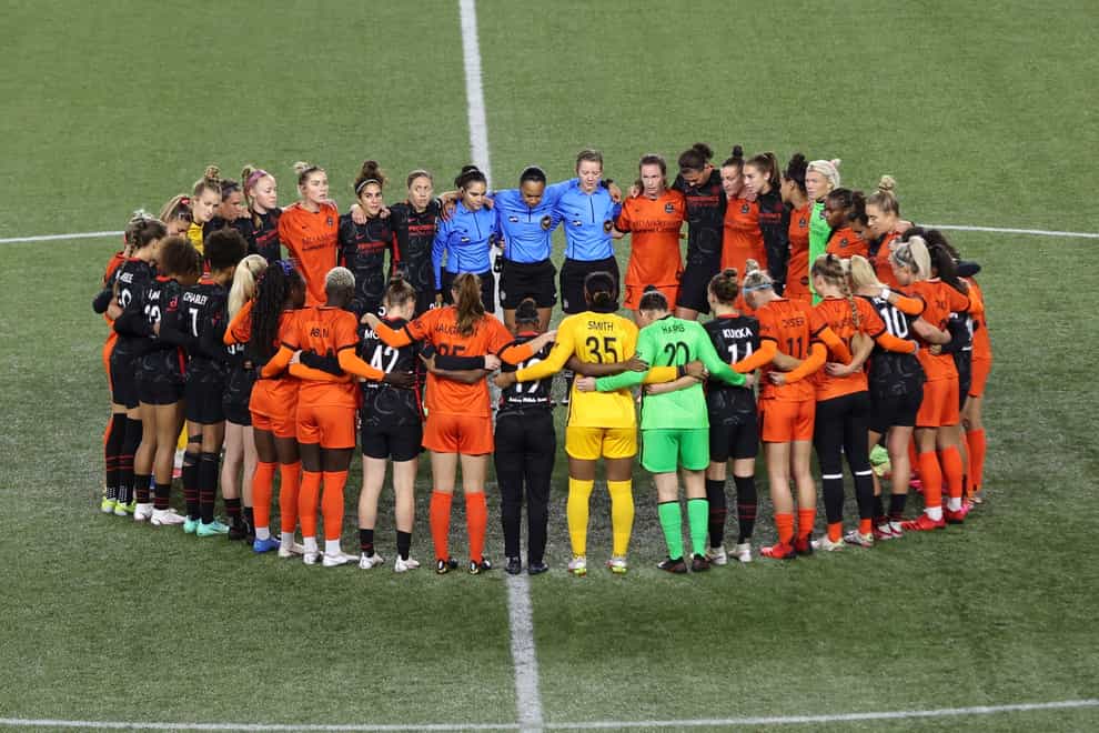 Players gather in the centre circle during the match between Portland Thorns and Houston Dash (Steve Dipaola/AP)