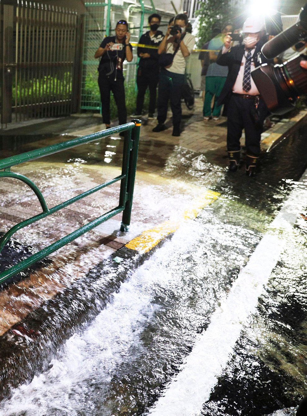 A road is soaked in water following an earthquake, in Tokyo (Kyodo via AP)