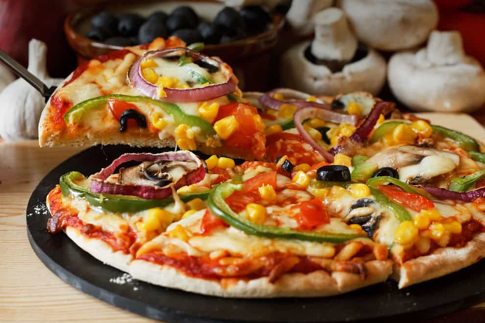 Vegetarian pizza topped with mushrooms, tomatoes, peppers, onions, sweetcorn and olives (ALAMY/PA)