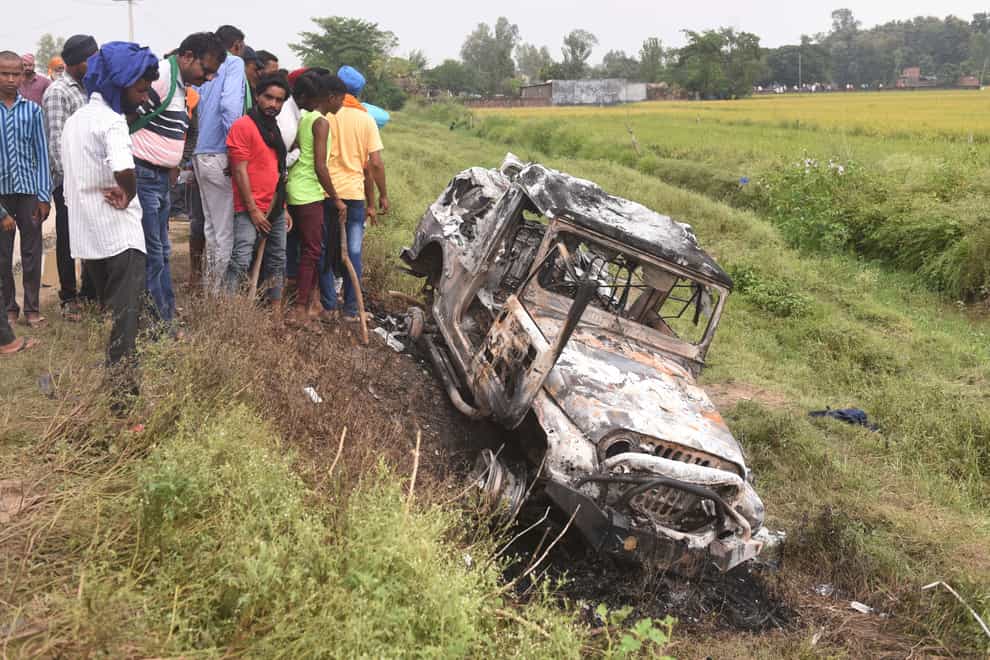 A burnt car which run over and killed farmers at Tikonia village in Lakhimpur Kheri (AP Photo)