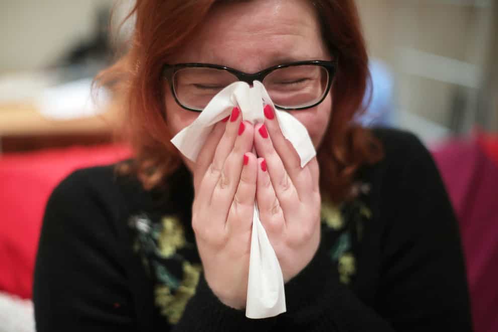 People are being urged not to grin and bear illness but stay away from the workplace if sick (Yui Mok/PA)