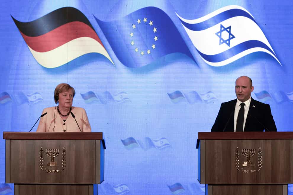 German Chancellor Angela Merkel and Israeli Prime Minister Naftali Bennett give a joint press conference following their meeting in Jerusalem (Menahem Kahana/Pool via AP)