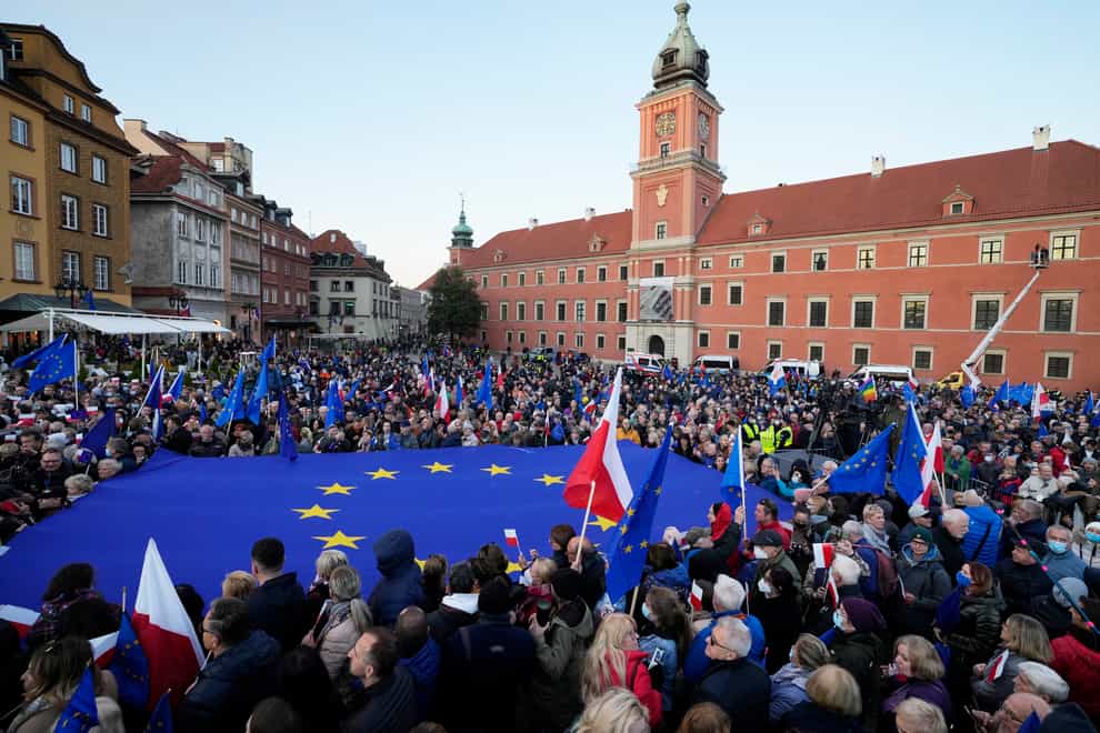 Demonstrators wave European Union and Polish flags in support of EU membership during a demonstration in Warsaw (Czarek Sokolowski/AP)