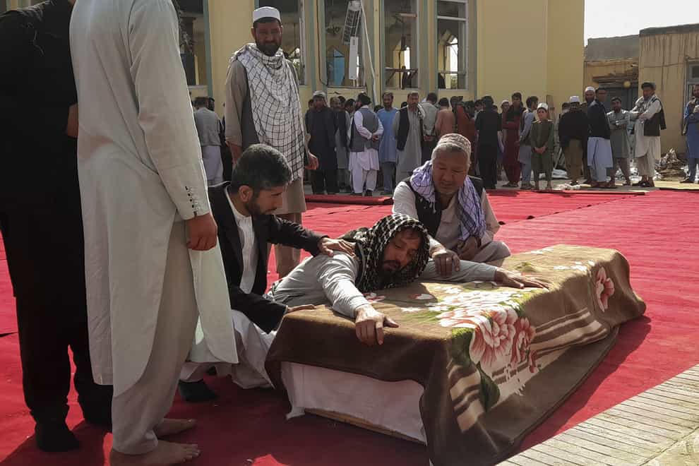 Relatives and residents attend a funeral ceremony for victims of a suicide attack at the Gozar-e-Sayed Abad Mosque in Kunduz, northern Afghanistan (AP)