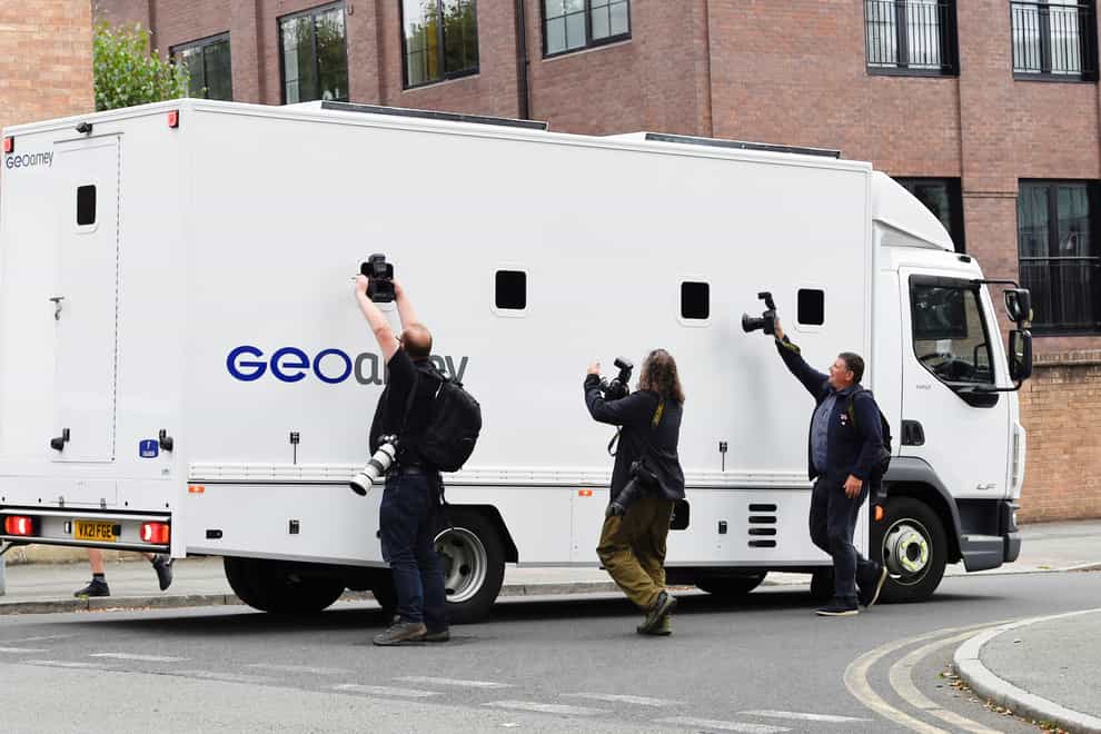 Photographers take pictures through the windows of a prison van carrying Manchester City footballer Benjamin Mendy as it leaves Chester Magistrates’ Court, Chester in August (PA)