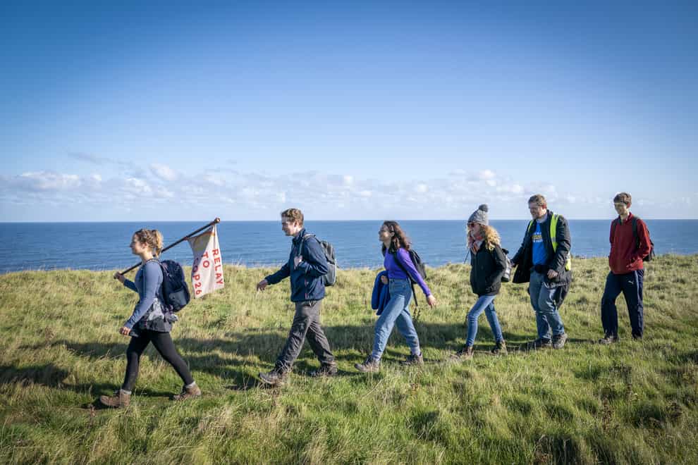 A group of activists from the Young Christian Climate Network (YCCN) cross the border near Berwick-upon-Tweed (Jane Barlow/PA)