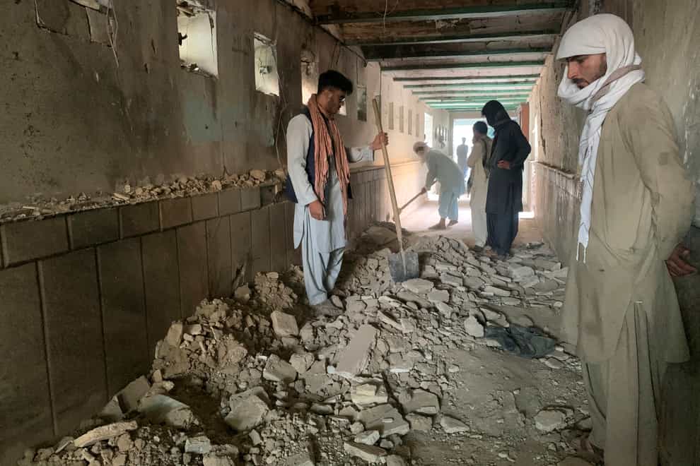 People inspect the inside of a mosque following a suicide bomb attack (Sidiqullah Khan/AP)