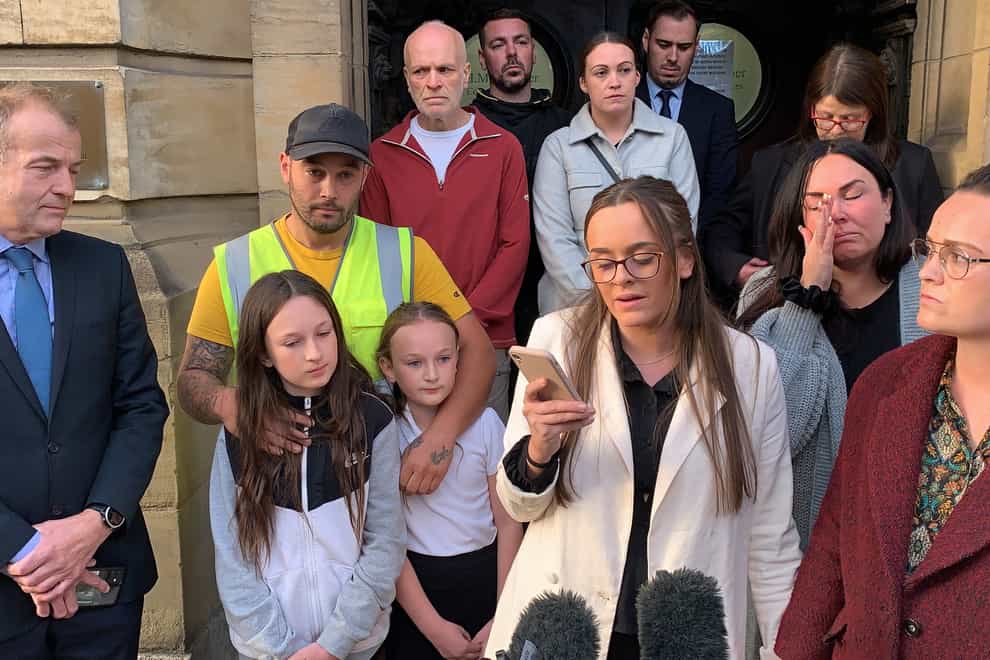 Tia Skelton (centre), the sister of Lewis Skelton, is surrounded by members of their family and solicitor Neil Hudgell (left) as she reads a statement to the media outside Hull Coroners Court (Dave Higgens/PA)