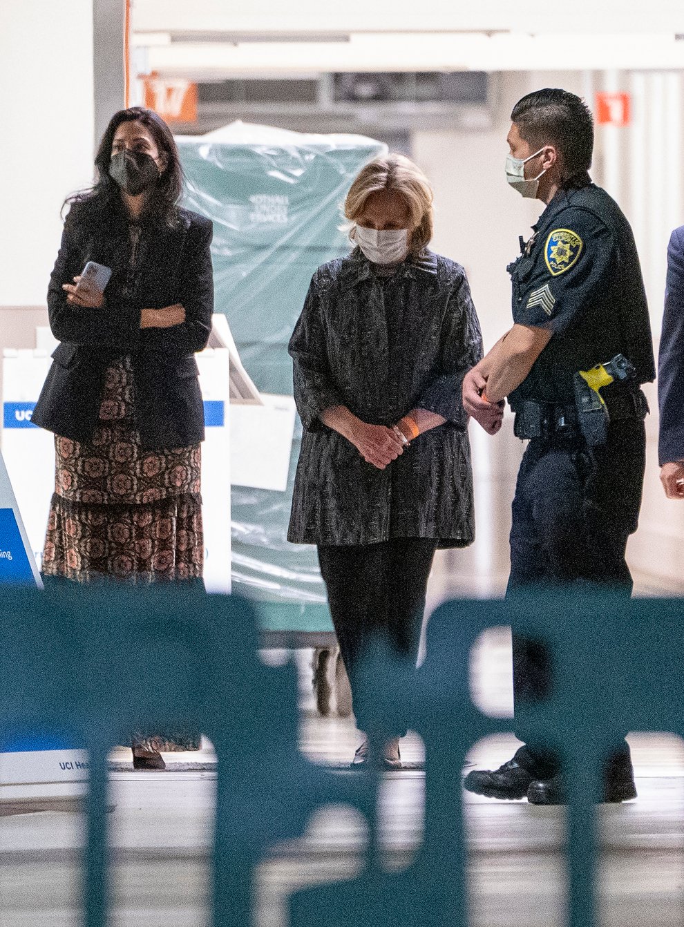Former first lady and former US Secretary of State Hillary Clinton, middle, exits the University of California Irvine Medical Centre in Orange (Damian Dovarganes/AP)
