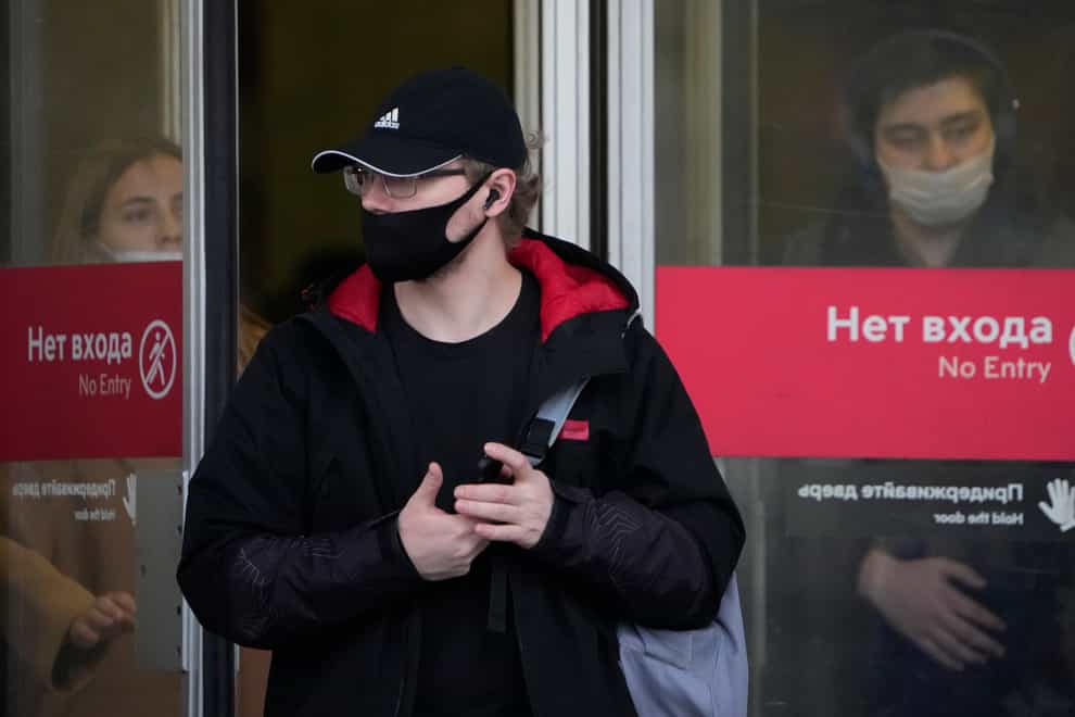 People wearing face masks to help curb the spread of coronavirus leave a subway in Moscow (Alexander Zemlianichenko/AP)