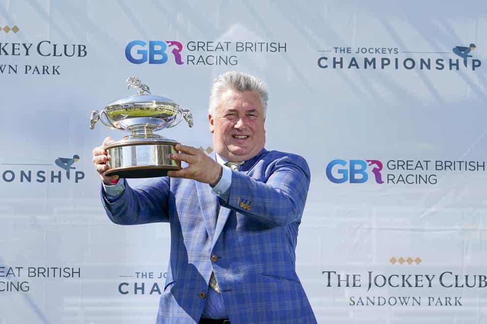Paul Nicholls with his Champion Trainer trophy for the national hunt season 2020-21 at Sandown Park Racecourse, Esher (Alan Crowhurst/PA)