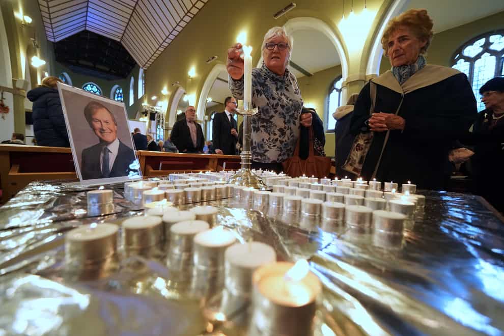 People light candles during a vigil at St Michael’s & All Angels church in Leigh-on-Sea in Essex for Conservative MP Sir David Amess (Kirsty O’Connor/PA)