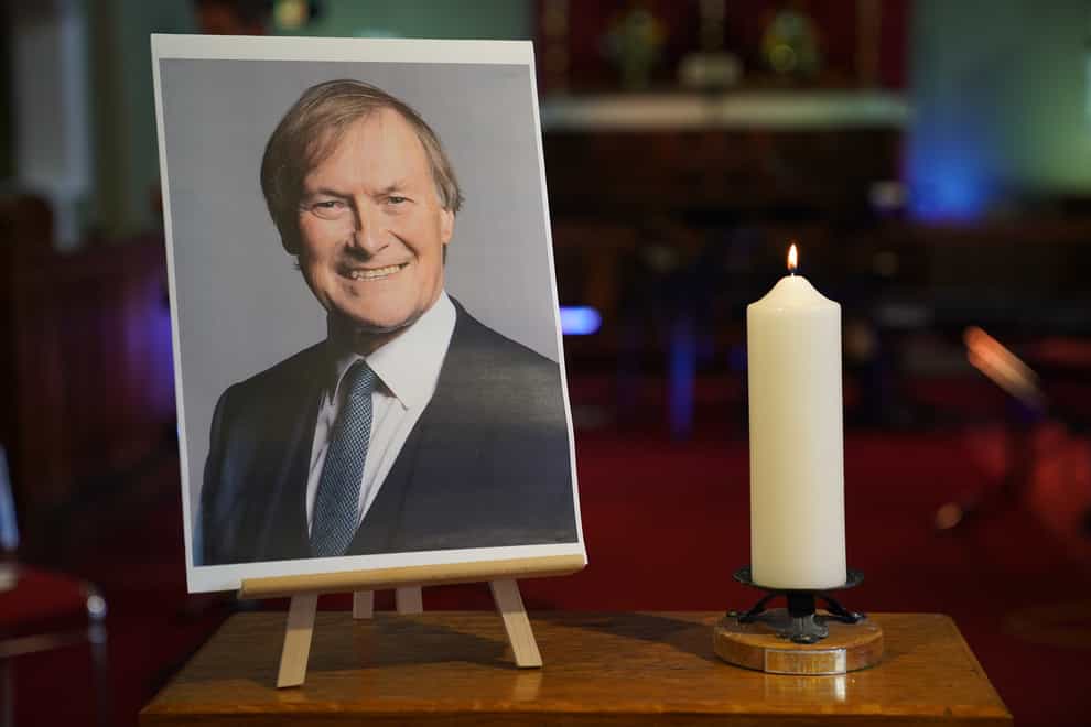 A candle and a photo at a vigil at St Michael & All Angels church in Leigh-on-Sea Essex (Kirsty O’Connor/PA)