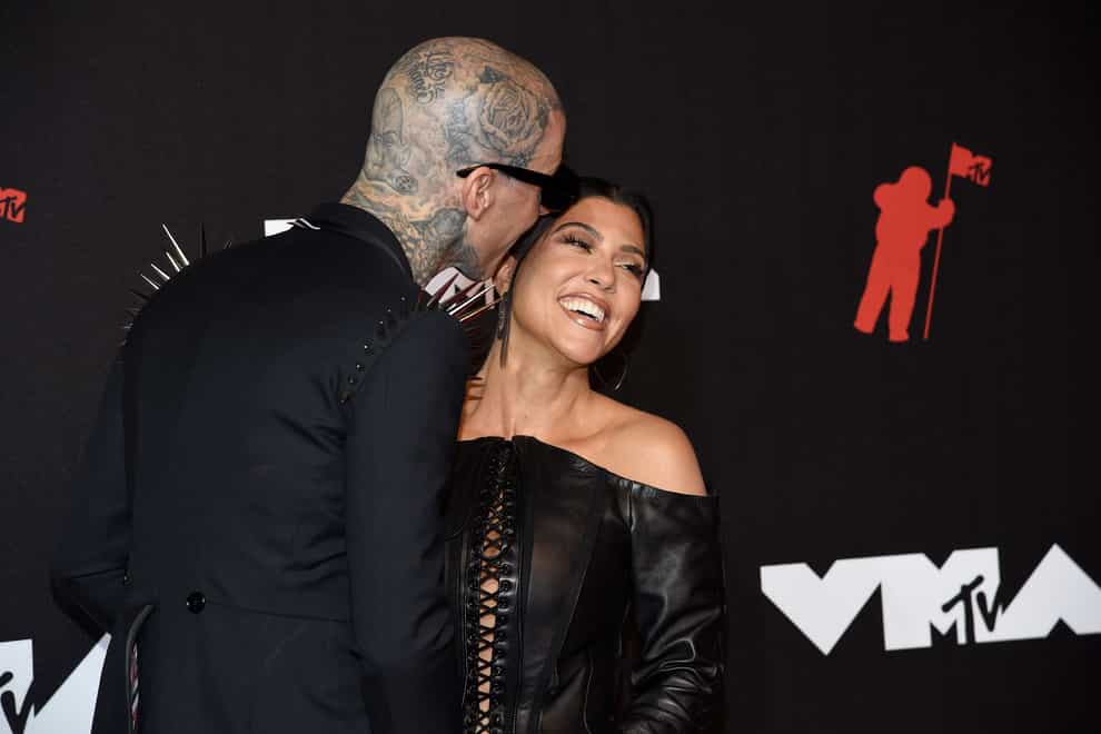 Kourtney Kardashian is now engaged to Blink-182 drummer Travis Barker following a day at the beach (Evan Agostini/Invision/AP)
