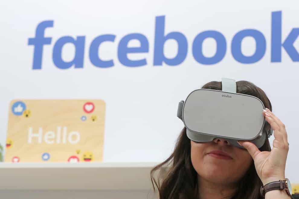 A woman uses an Oculus virtual reality headset at the Facebook stand during the Dublin Tech Summit (Niall Carson/PA)