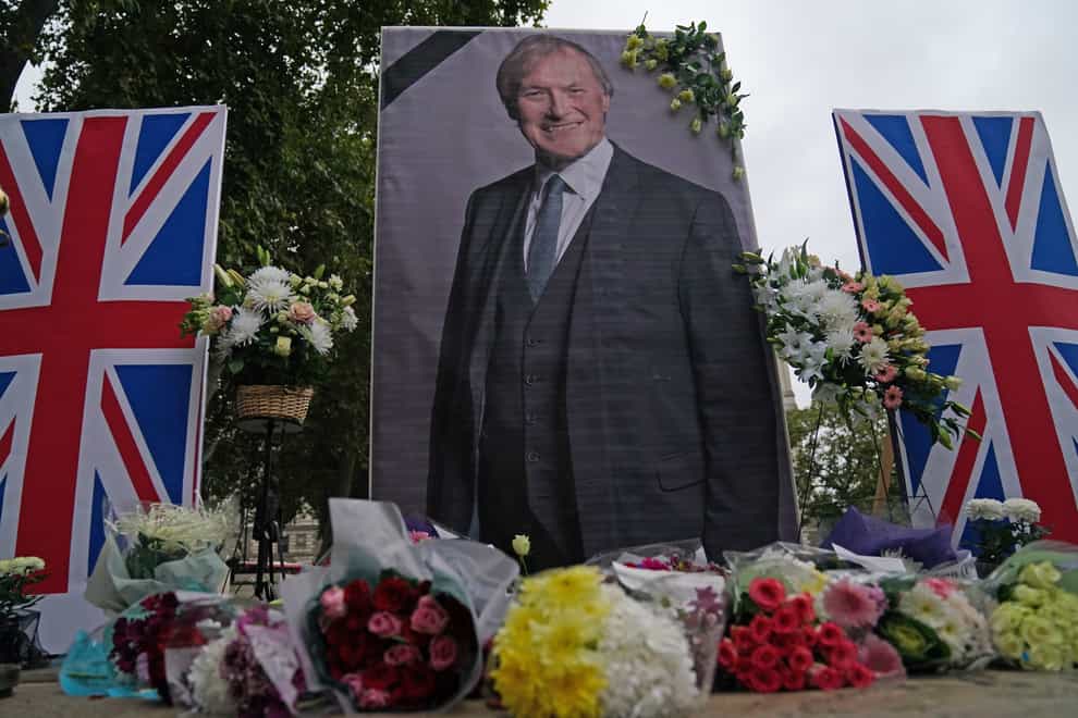 People from the UK Iranian community hold a vigil for Sir David Amess in Parliament Square (Victoria Jones/PA)