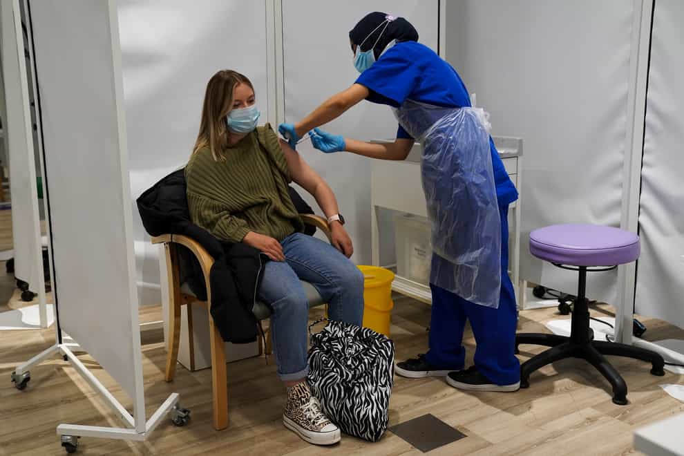 A person receives a Covid-19 Pfizer jab at a pop-up vaccination centre at Westfield Stratford City shopping centre in east London (Kirsty O’Connor/PA)