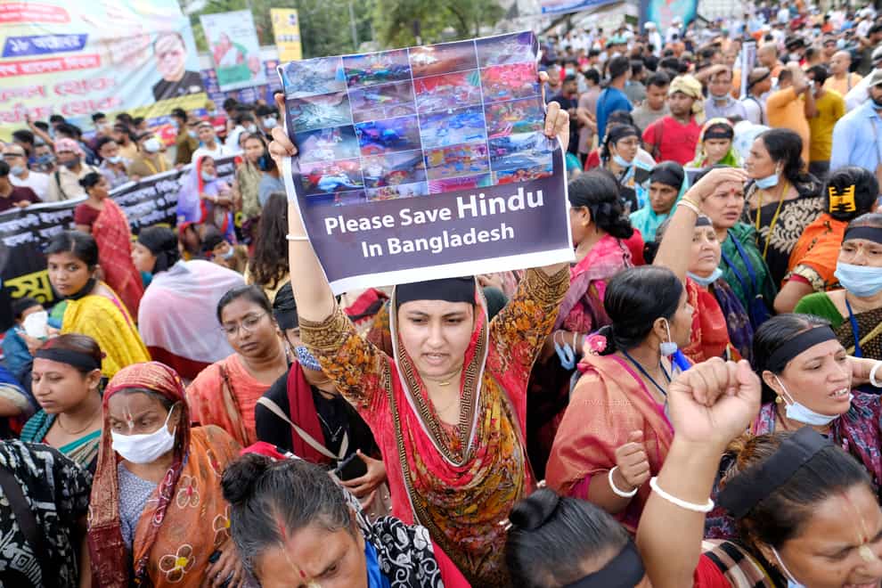 Hundreds of Hindus protesting against attacks on temples and the killing of two Hindu devotees in another district shout slogans in Dhaka, Bangladesh (Mahmud Hossain Opu/AP)