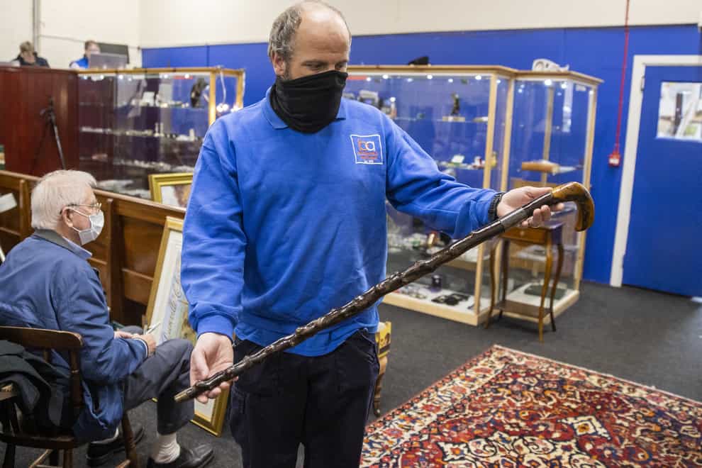 A member of the Bloomfield Auctions team holds a walking stick once owned by Northern Ireland’s first prime minister, James Craig (Liam McBurney/PA)