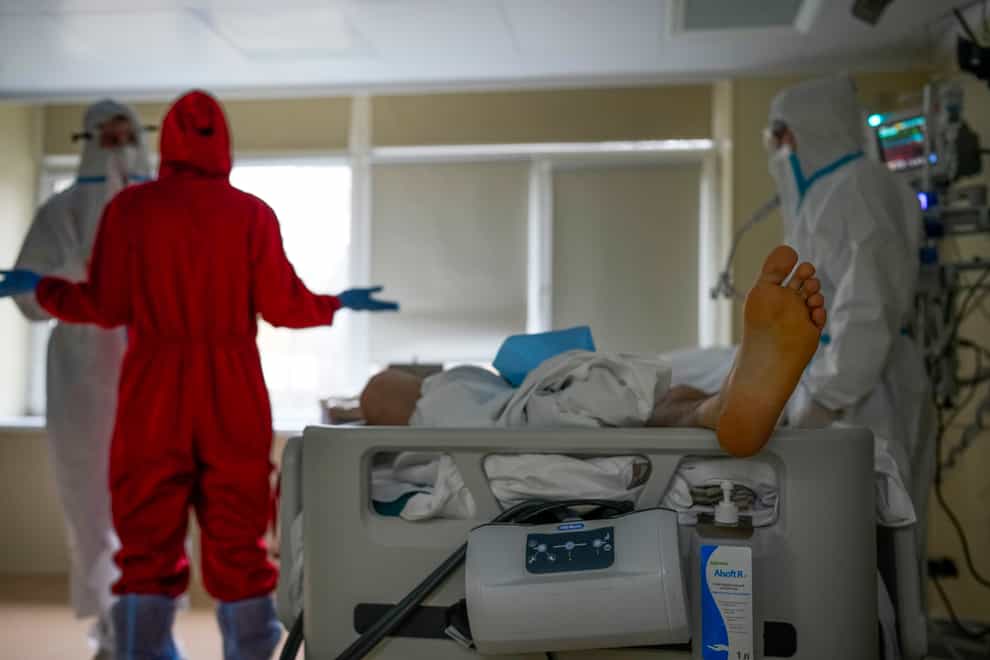 Medical staff wearing protective gear look after a coronavirus patient in a Moscow hospital (AP Photo/Alexander Zemlianichenko)